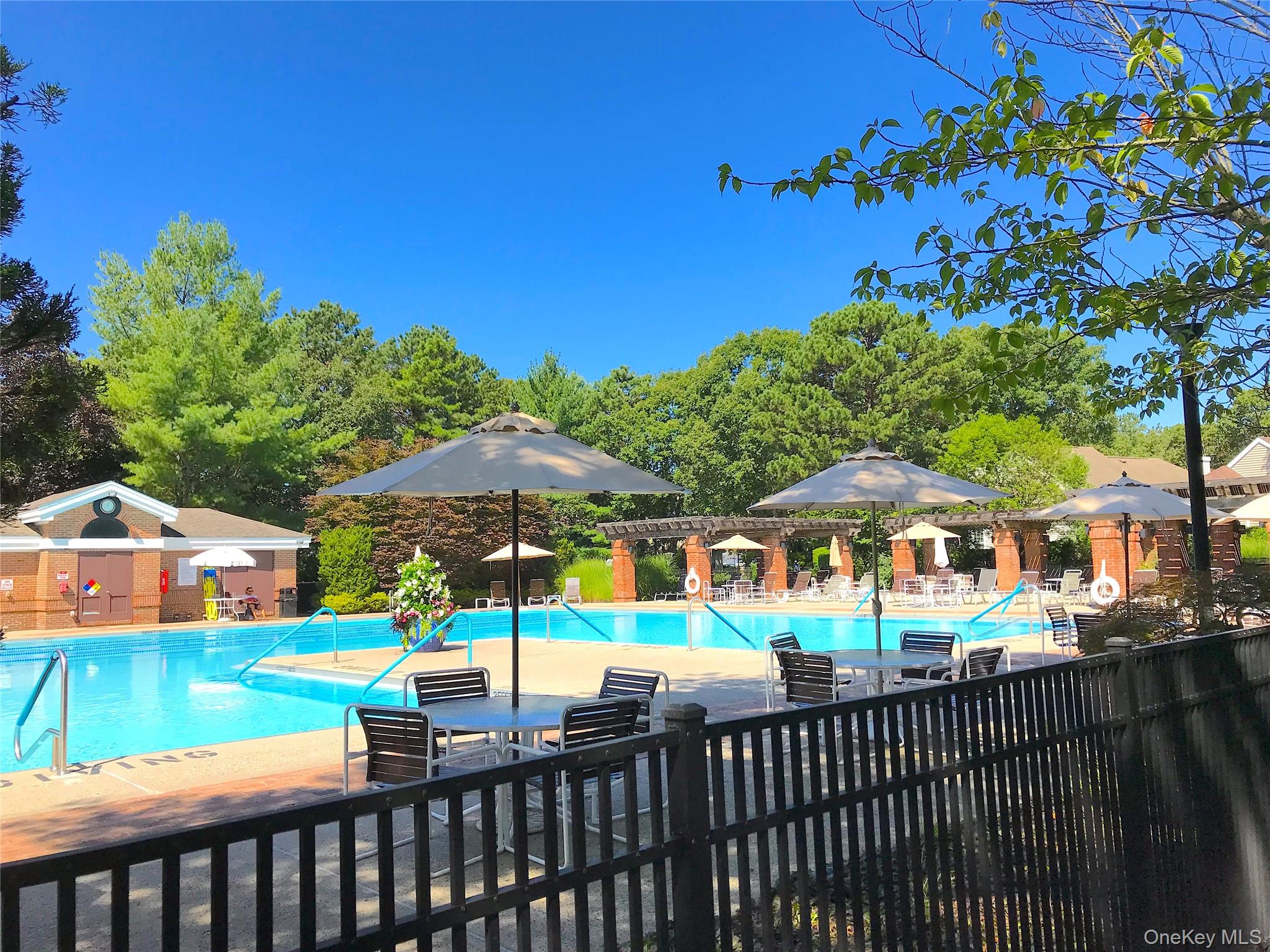 10 Oakdale Court Ridge, NY 11961 - Photo 34 of 41 a view of a swimming pool with a patio