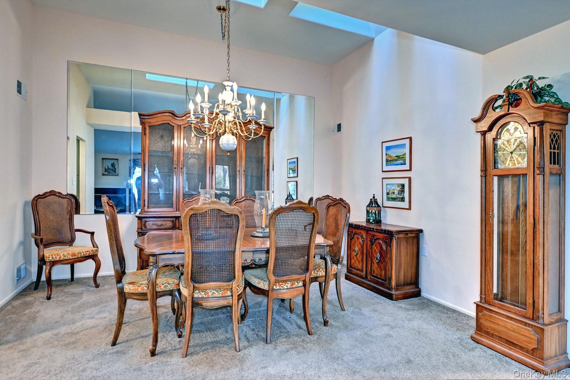 10 Oakdale Court Ridge, NY 11961 - Photo 10 of 41 a view of a dining room with furniture and chandelier