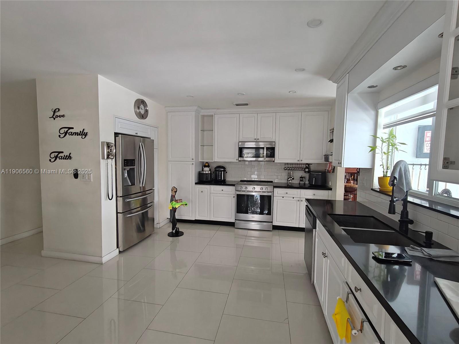 14444 Southwest 107th Terrace Miami, FL 33186 - Photo 16 of 73 a kitchen with a refrigerator and a stove top oven