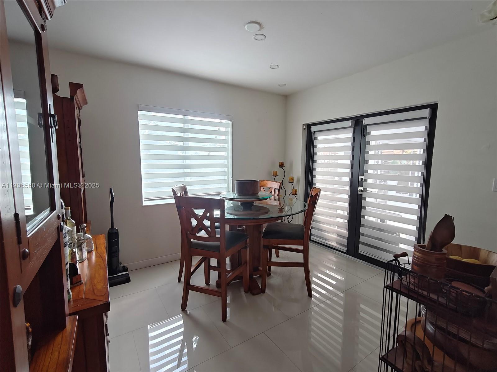 14444 Southwest 107th Terrace Miami, FL 33186 - Photo 18 of 73 a view of a dining room with furniture and a window