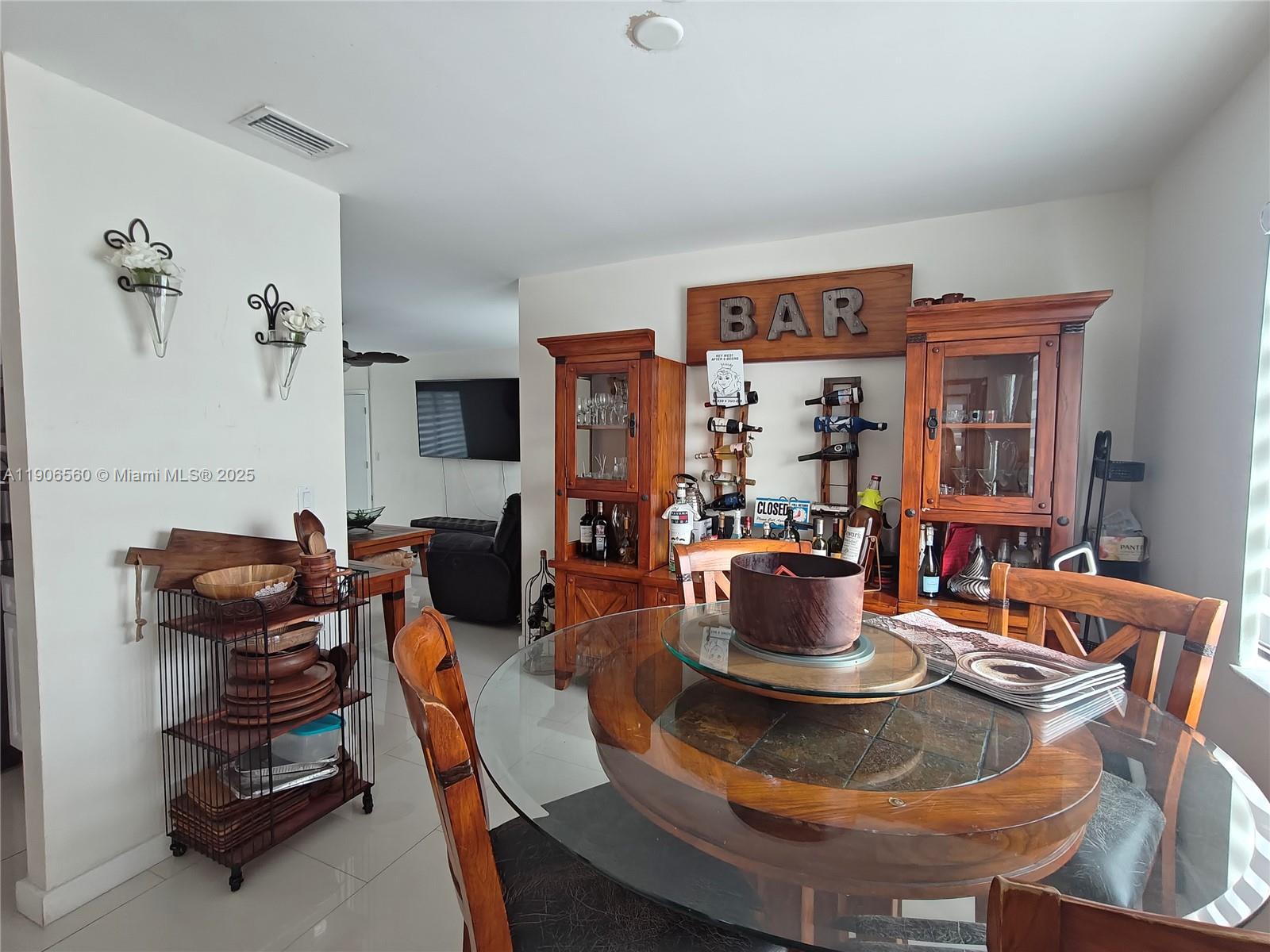14444 Southwest 107th Terrace Miami, FL 33186 - Photo 19 of 73 a dining room with furniture a chandelier and a fireplace