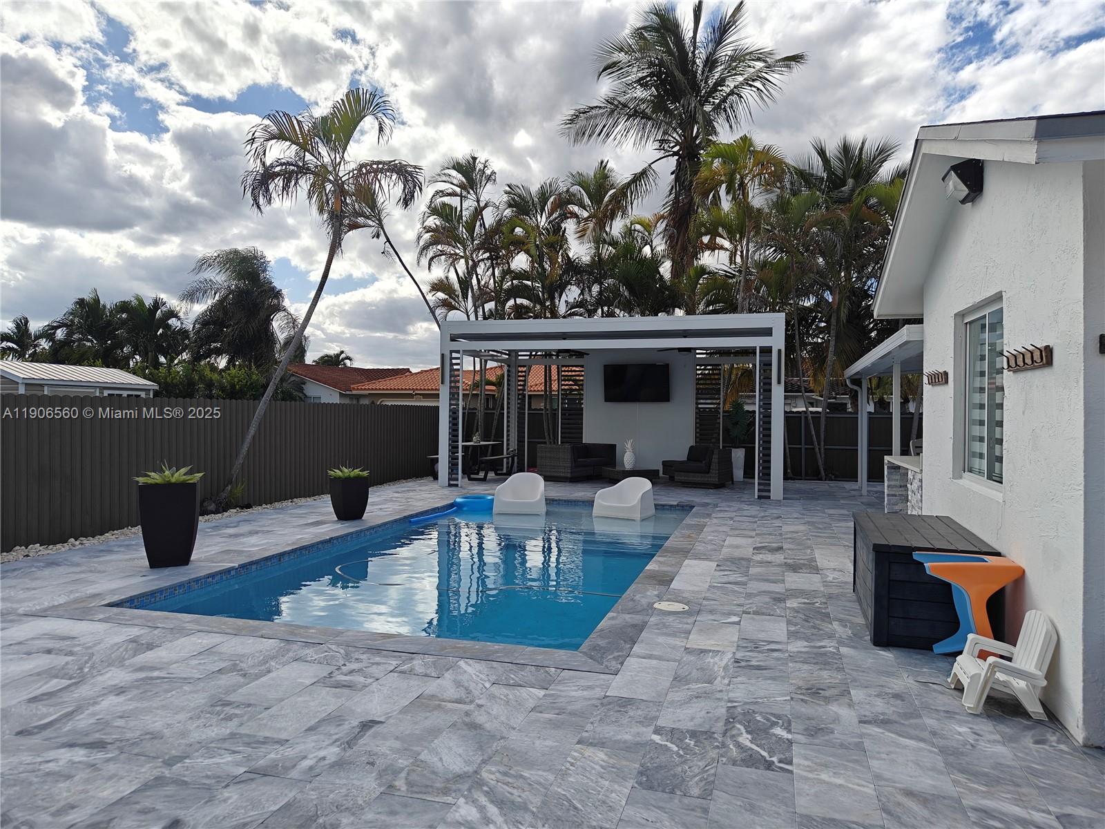 14444 Southwest 107th Terrace Miami, FL 33186 - Photo 2 of 73 a view of a house with backyard porch and sitting area