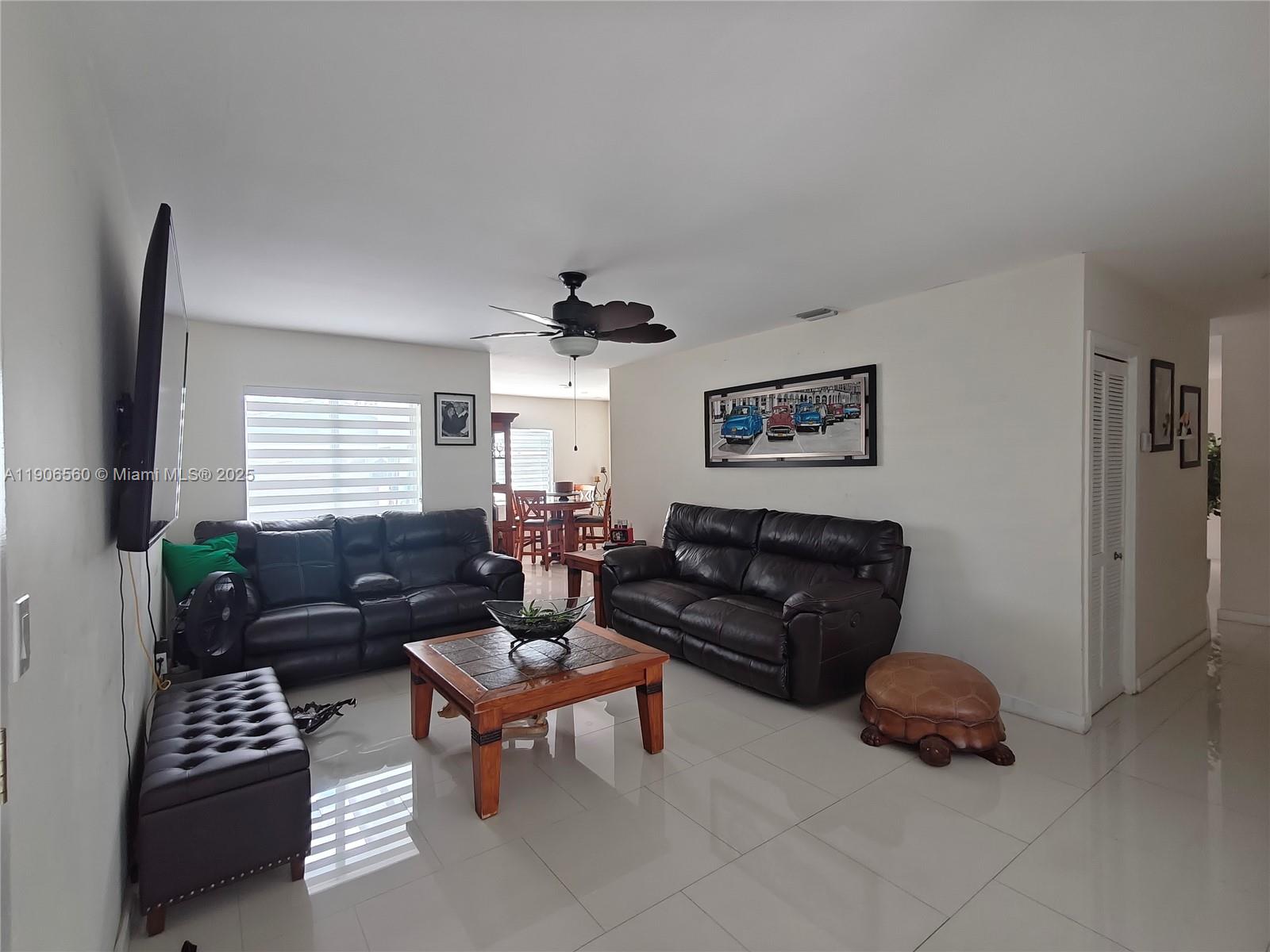 14444 Southwest 107th Terrace Miami, FL 33186 - Photo 23 of 73 a living room with furniture and a window