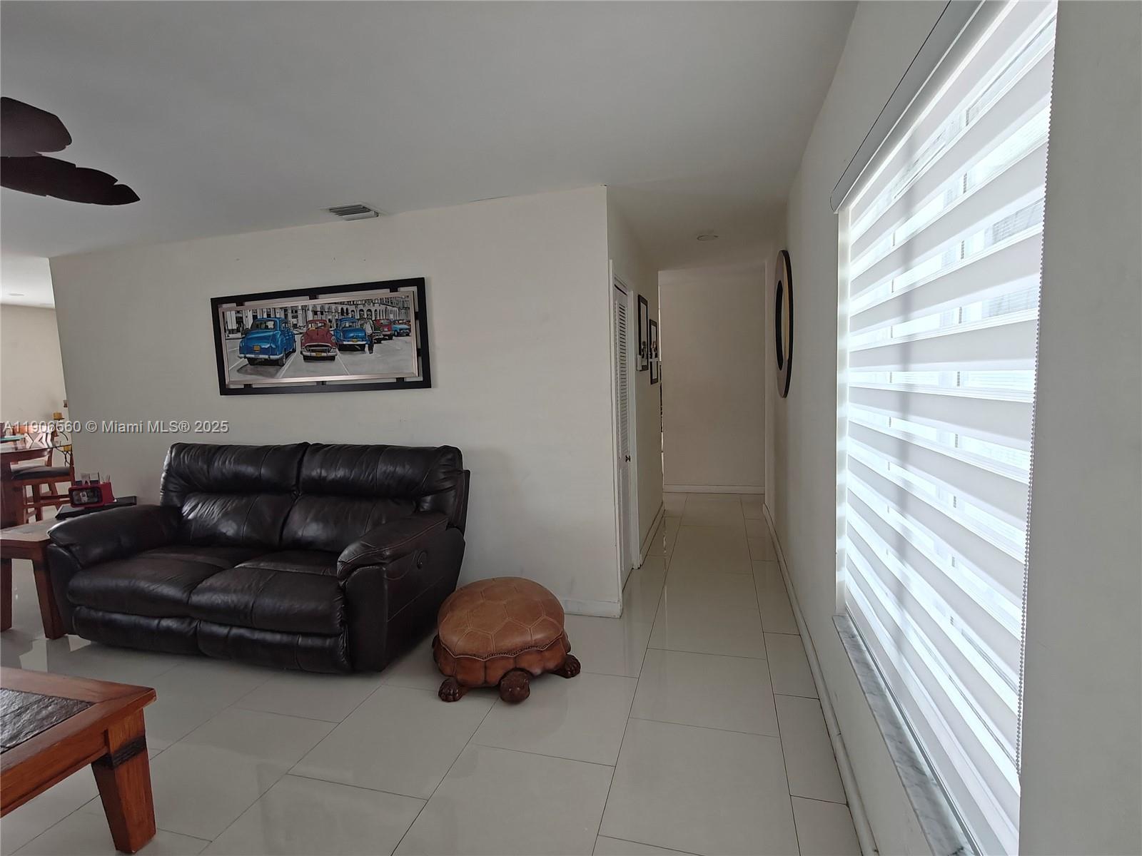 14444 Southwest 107th Terrace Miami, FL 33186 - Photo 24 of 73 a living room with furniture and a large window