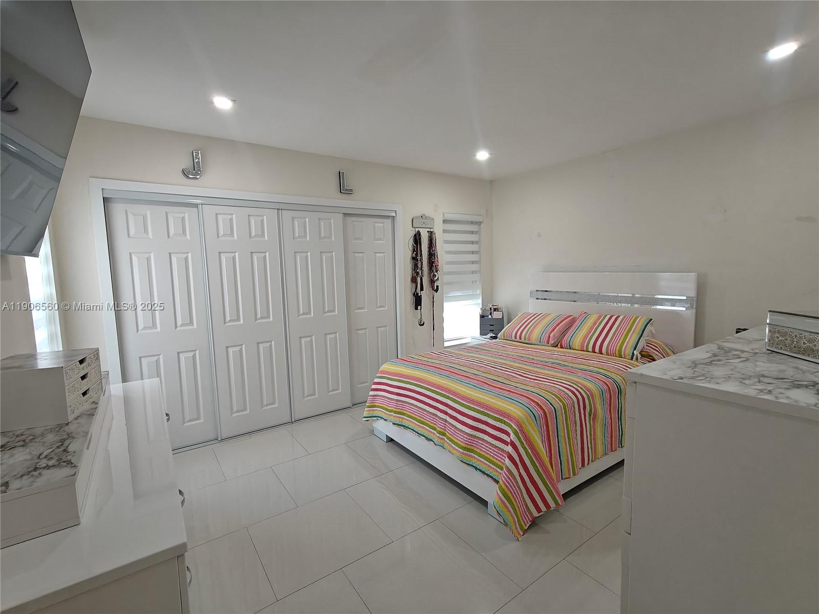 14444 Southwest 107th Terrace Miami, FL 33186 - Photo 36 of 73 a bedroom with a bed and a walk in closet