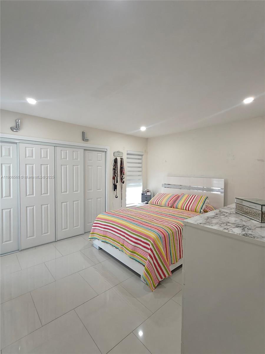 14444 Southwest 107th Terrace Miami, FL 33186 - Photo 37 of 73 a bedroom with a bed and a walk in closet