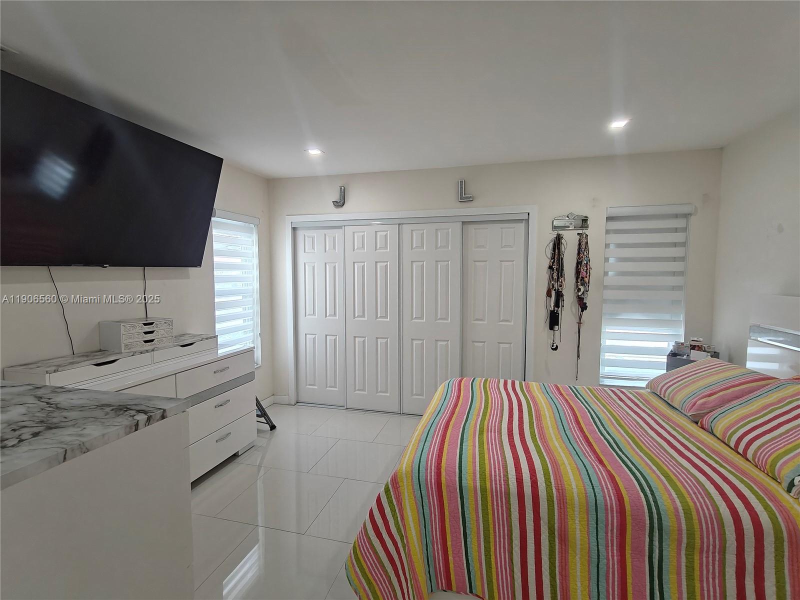 14444 Southwest 107th Terrace Miami, FL 33186 - Photo 38 of 73 a bedroom with a bed and a flat screen tv