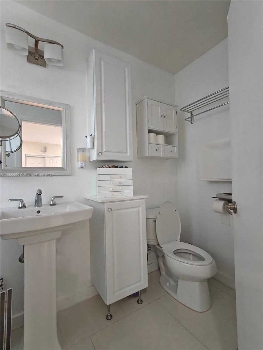 14444 Southwest 107th Terrace Miami, FL 33186 - Photo 40 of 73 a bathroom with a toilet sink and mirror