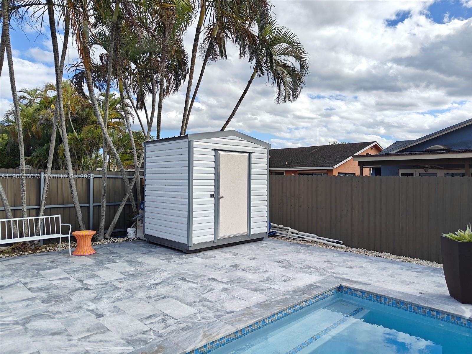 14444 Southwest 107th Terrace Miami, FL 33186 - Photo 48 of 73 a backyard of a house with fountain table and entertaining space
