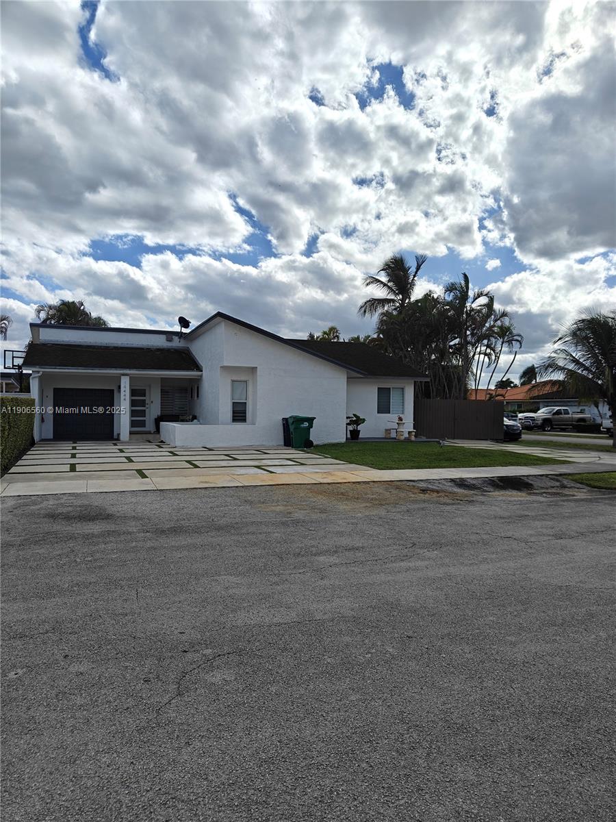 14444 Southwest 107th Terrace Miami, FL 33186 - Photo 5 of 73 a front view of a house with a garden