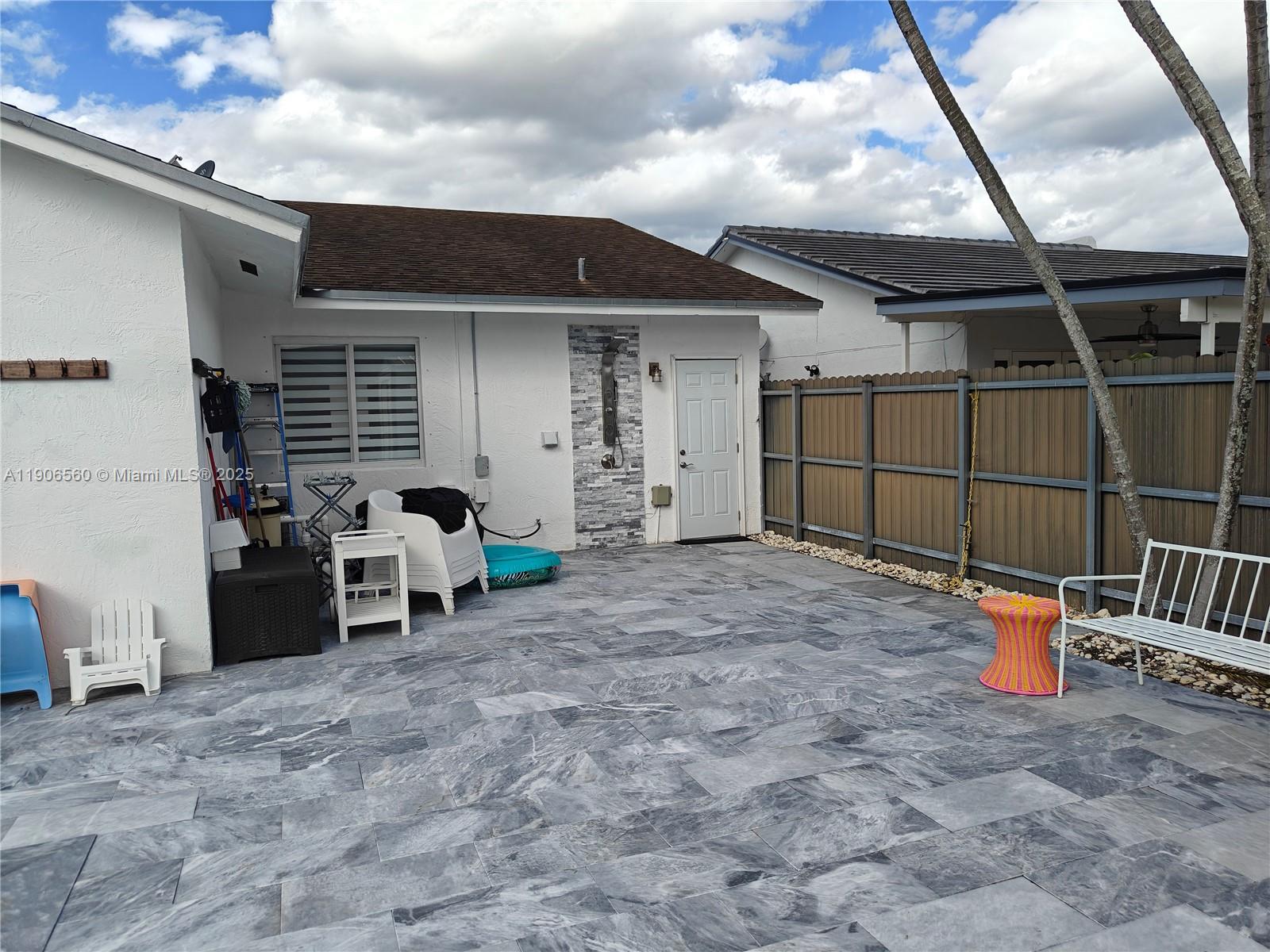14444 Southwest 107th Terrace Miami, FL 33186 - Photo 56 of 73 a view of a chair and table in the patio