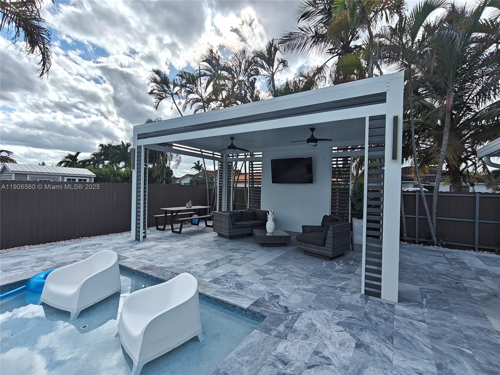 14444 Southwest 107th Terrace Miami, FL 33186 - Photo 58 of 73 a view of a porch with furniture and a yard