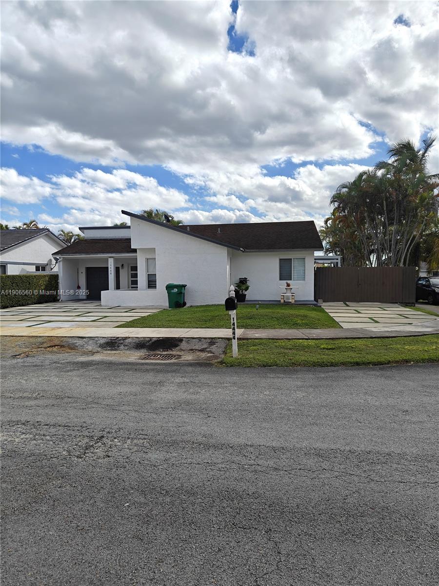14444 Southwest 107th Terrace Miami, FL 33186 - Photo 6 of 73 a front view of a house with a big yard