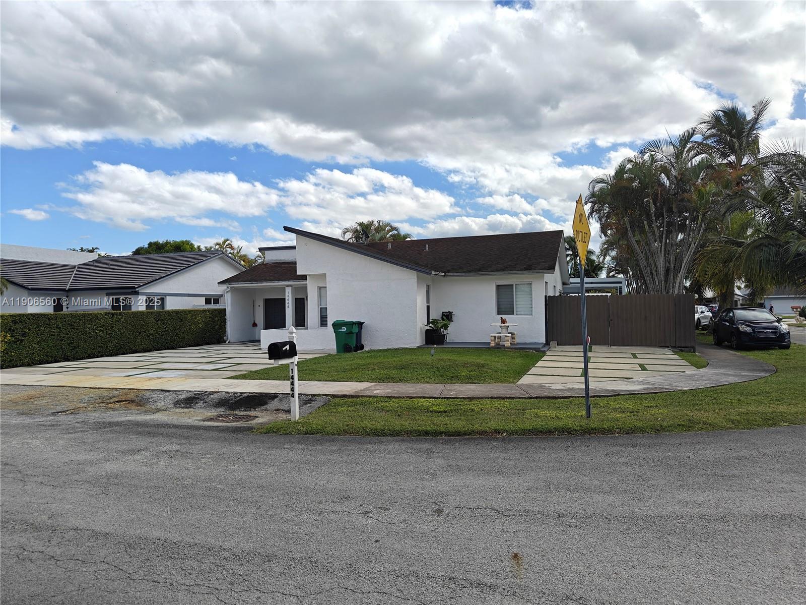 14444 Southwest 107th Terrace Miami, FL 33186 - Photo 7 of 73 a front view of a house with a yard