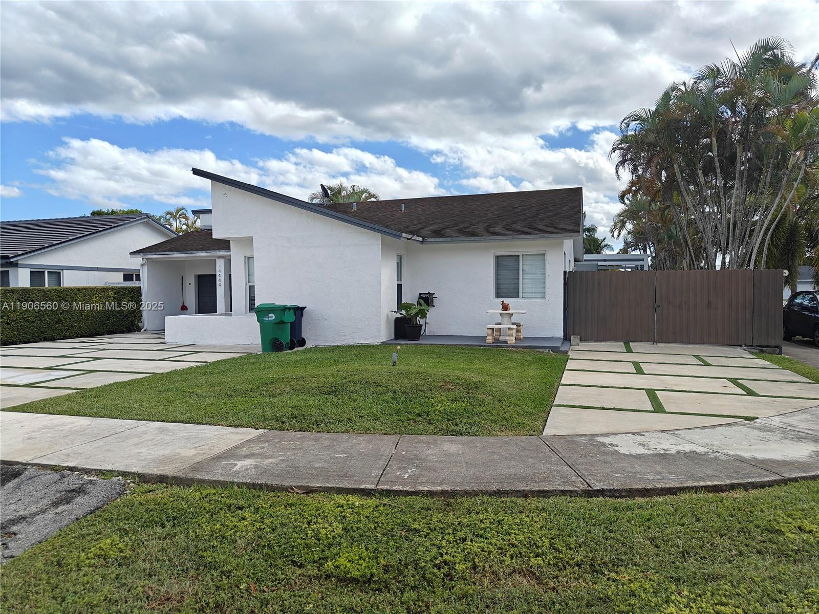 14444 Southwest 107th Terrace Miami, FL 33186 - Photo 8 of 73 a front view of a house with a yard and garage