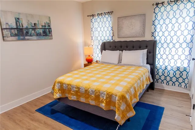 a bedroom with a bed and wooden floor