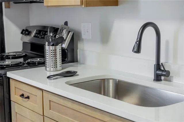 a kitchen with a sink cabinets and appliances