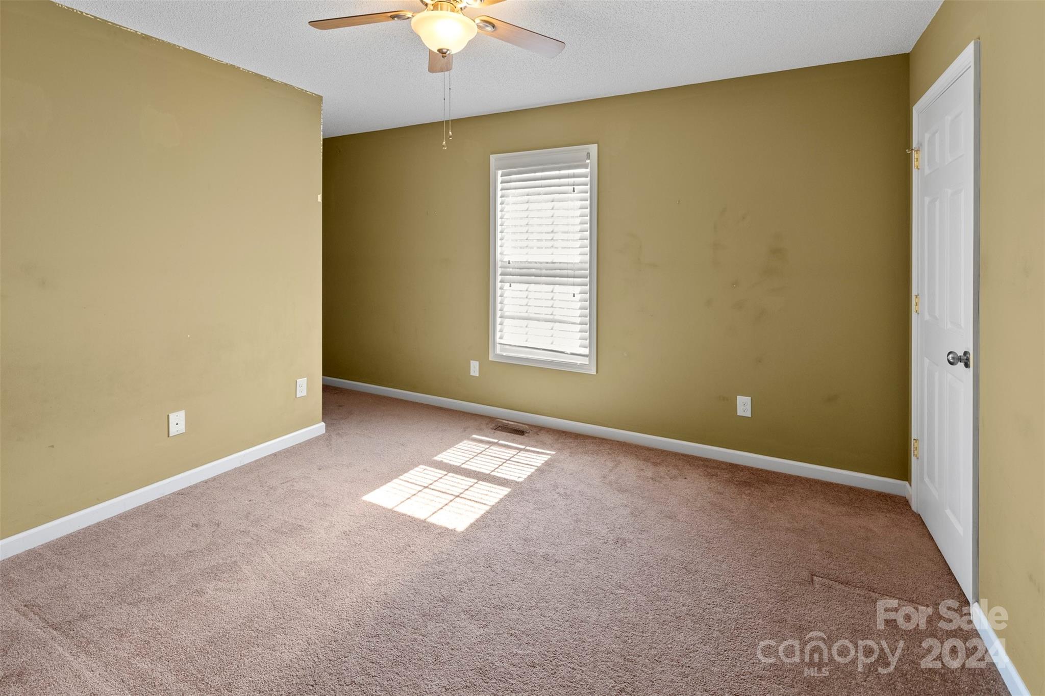 3624 Deerbrook Road Lenoir, NC 28645 - Photo 14 of 28 an empty room with windows and chandelier fan