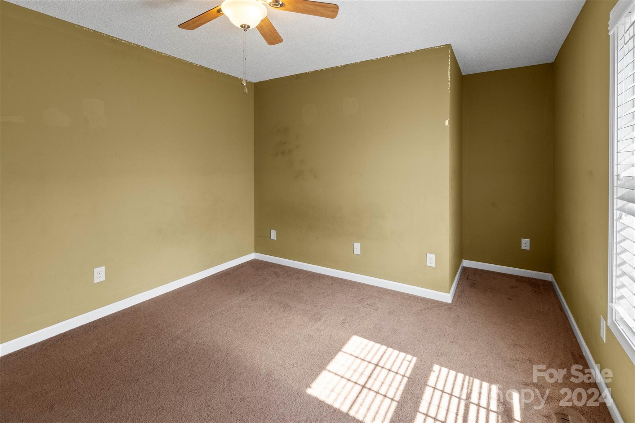 3624 Deerbrook Road Lenoir, NC 28645 - Photo 15 of 28 an empty room with a ceiling fan and a window