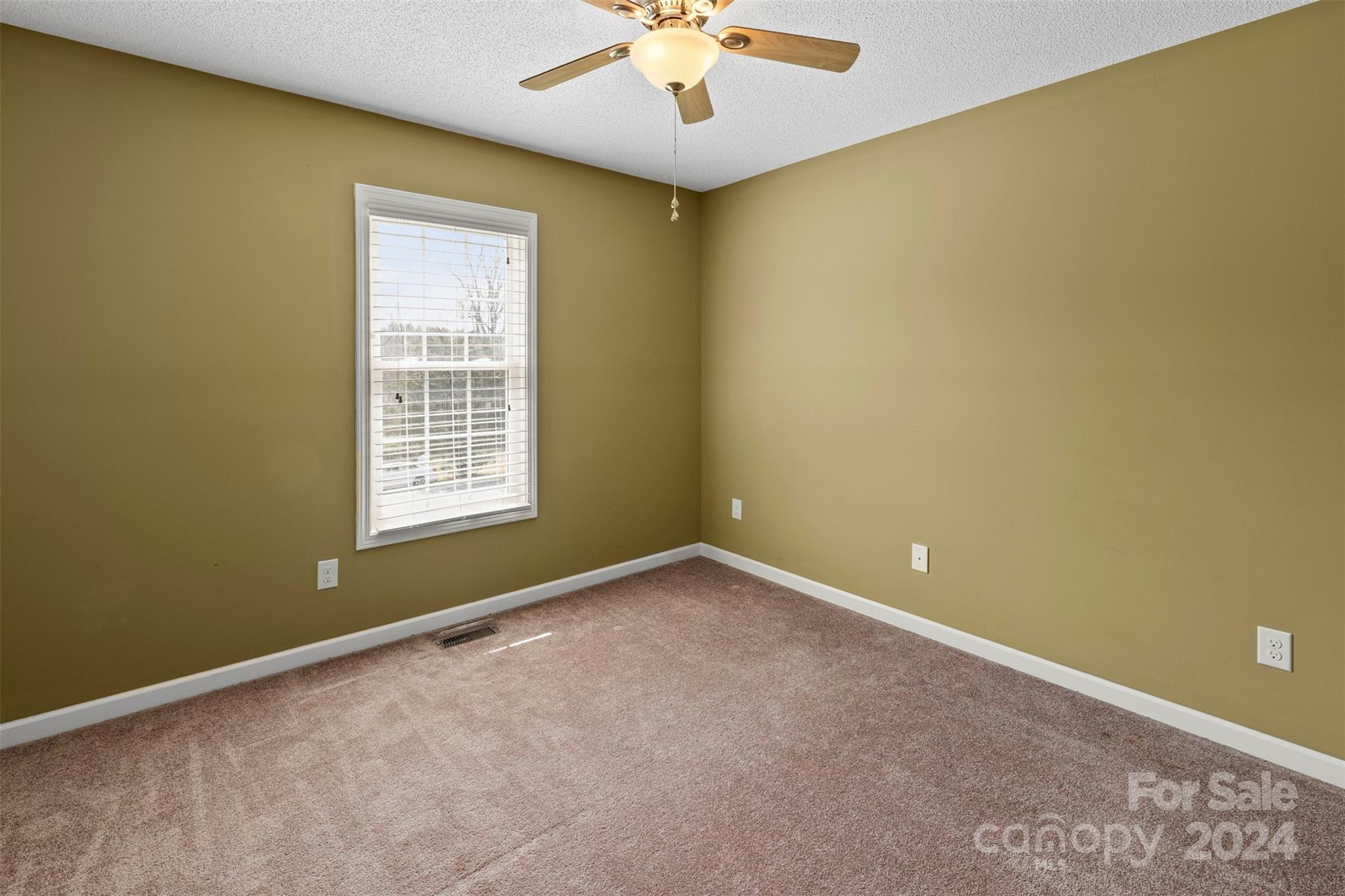 3624 Deerbrook Road Lenoir, NC 28645 - Photo 17 of 28 an empty room with a chandelier fan and windows