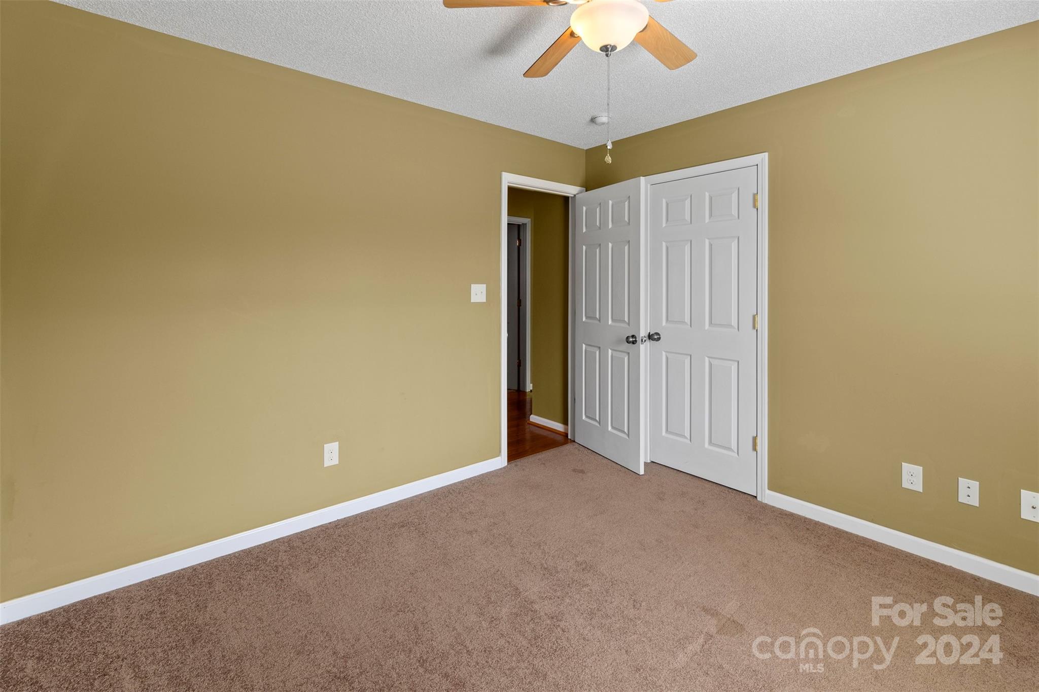 3624 Deerbrook Road Lenoir, NC 28645 - Photo 18 of 28 an empty room with a ceiling fan and a window