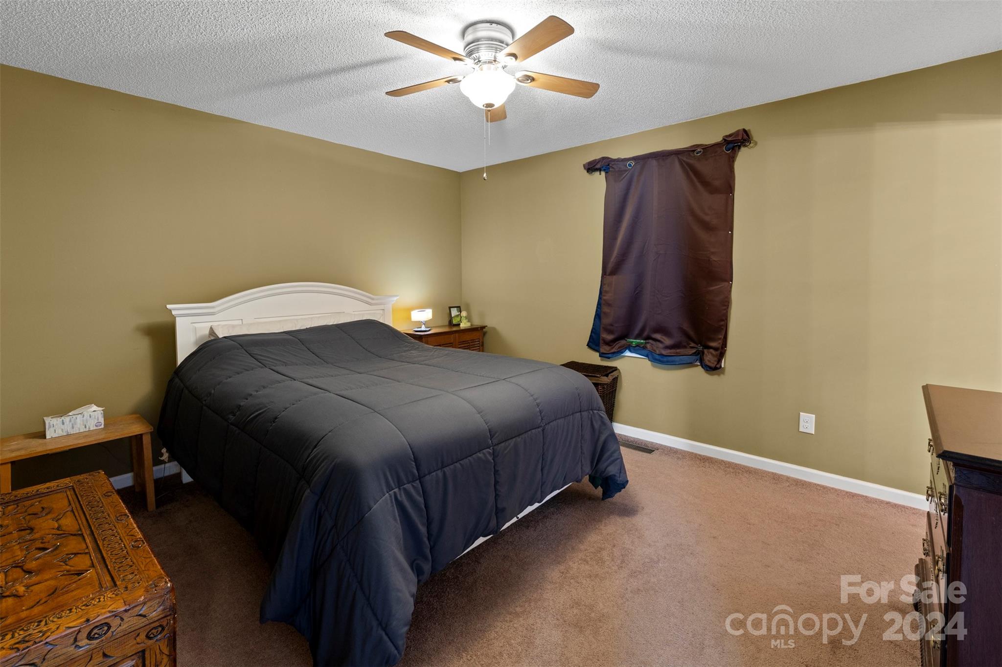 3624 Deerbrook Road Lenoir, NC 28645 - Photo 19 of 28 a bedroom with a bed and a chandelier