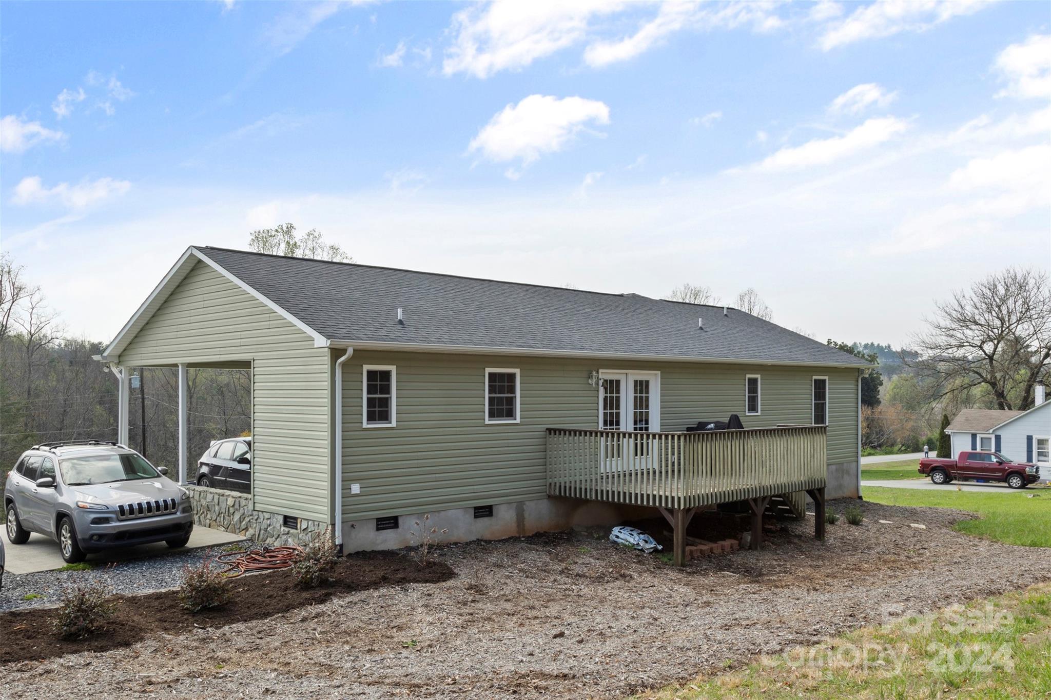 3624 Deerbrook Road Lenoir, NC 28645 - Photo 4 of 28 a view of a house with a backyard and a patio