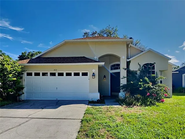 a front view of house with a garden