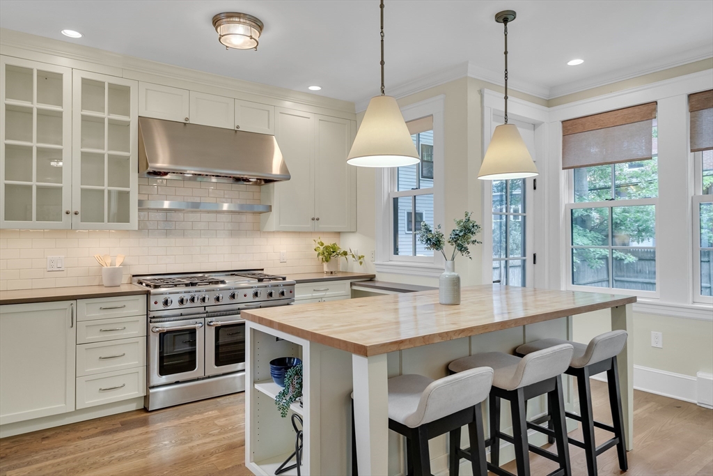 2 Percy Place Cambridge, MA 02139 - Photo 11 of 37 a kitchen with a stove a window and wooden floor