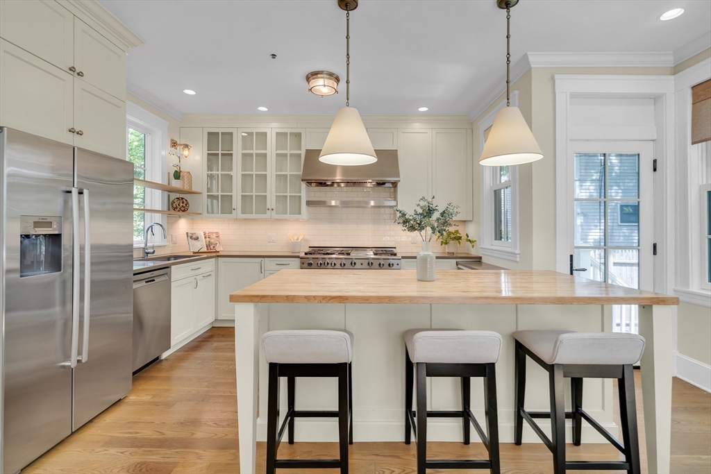 2 Percy Place Cambridge, MA 02139 - Photo 14 of 37 a kitchen with kitchen island granite countertop a sink and stainless steel appliances