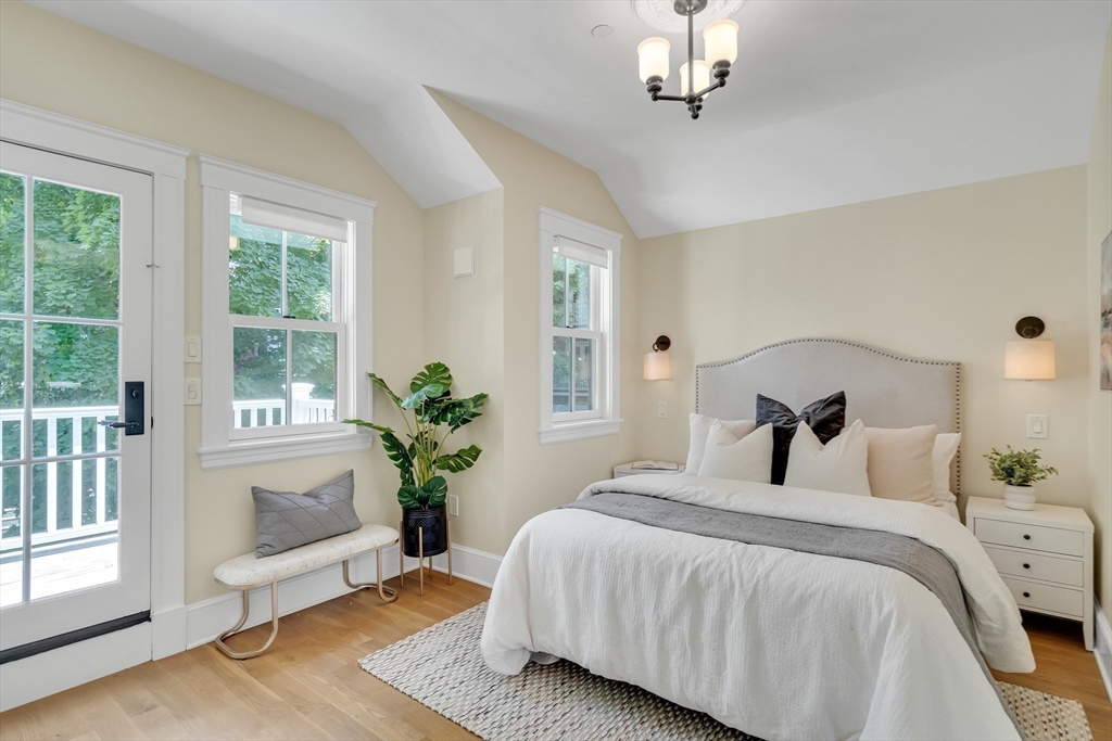 2 Percy Place Cambridge, MA 02139 - Photo 17 of 37 a bedroom with a balcony a bed and a chandelier
