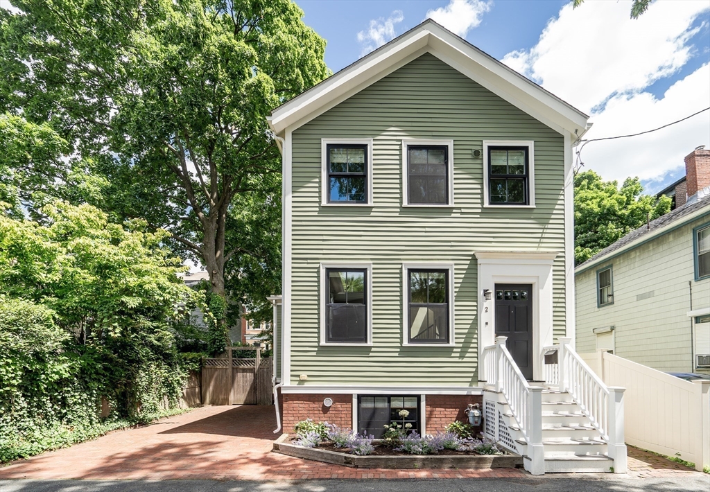 2 Percy Place Cambridge, MA 02139 - Photo 2 of 37 a front view of a house with a yard
