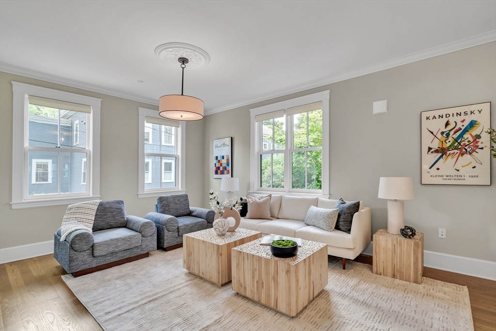 2 Percy Place Cambridge, MA 02139 - Photo 6 of 37 a living room with furniture and a chandelier
