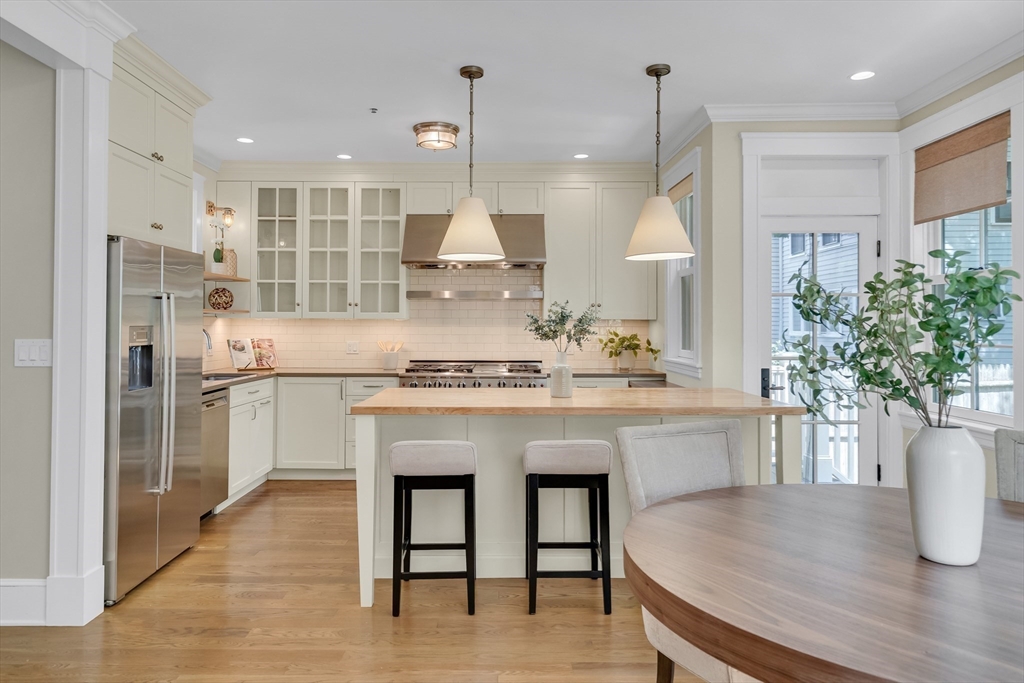 2 Percy Place Cambridge, MA 02139 - Photo 10 of 37 a kitchen with kitchen island white cabinets and stainless steel appliances