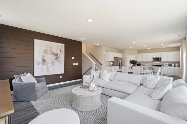 a living room with furniture and kitchen view