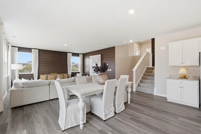 a view of a dining room with furniture window and wooden floor