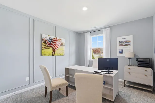 a view of a dining room with furniture and a window