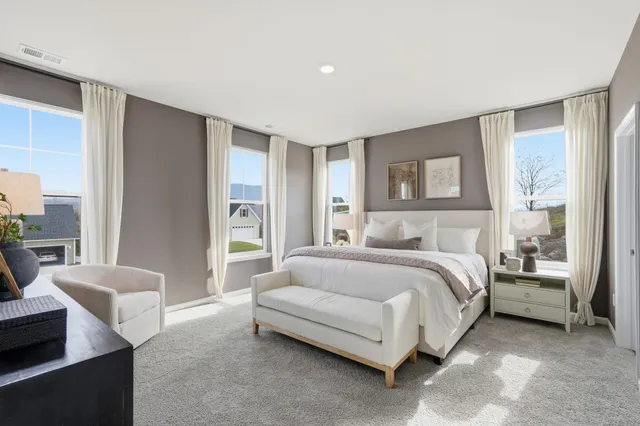 a spacious bedroom with a bed and a couch