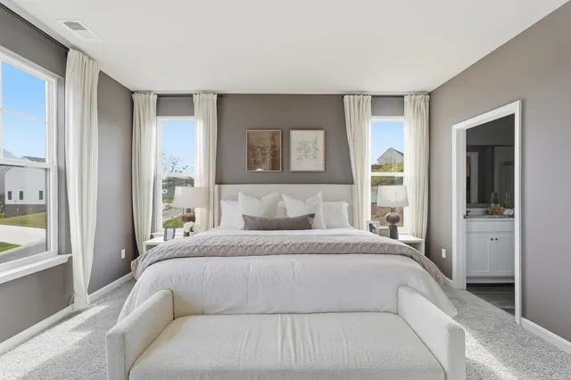 a bedroom with a large bed and a large window