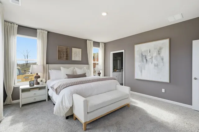 a spacious bedroom with a bed and a couch