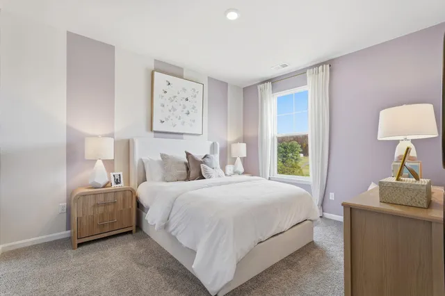 a bedroom with a bed and a lamp