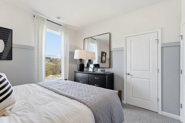 a bedroom with a bed and a dresser