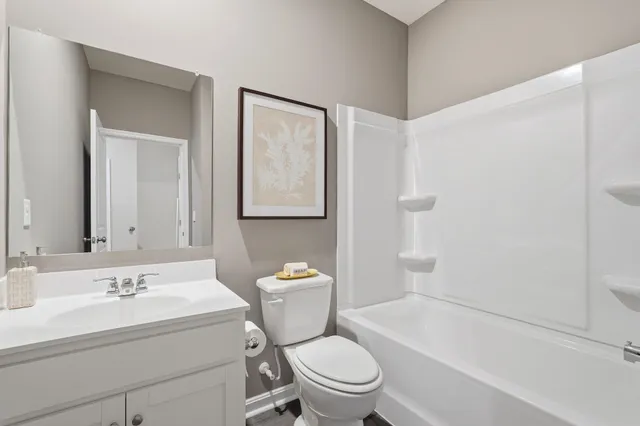 a white toilet sitting next to a bathroom sink