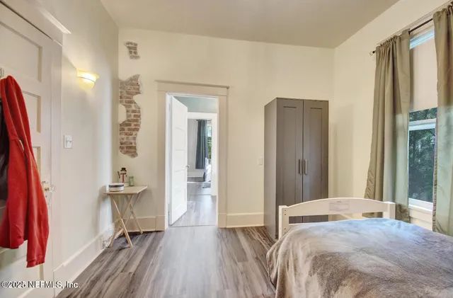 a bedroom with a bed and a large mirror