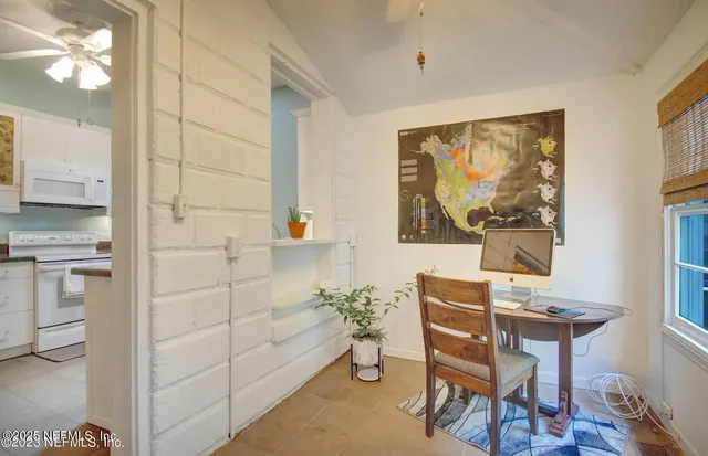 a dining room with furniture and window