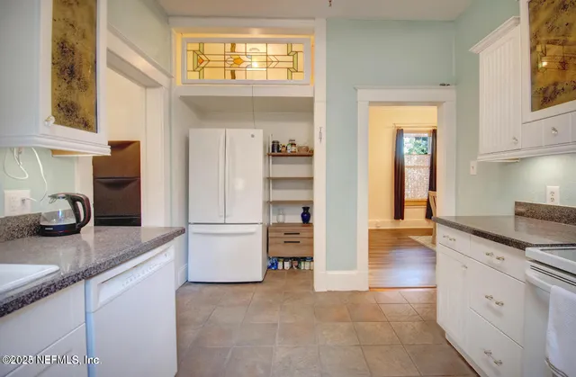 a kitchen with a refrigerator and a sink