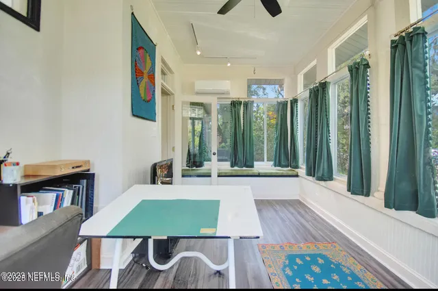a view of a dining room with furniture window and wooden floor
