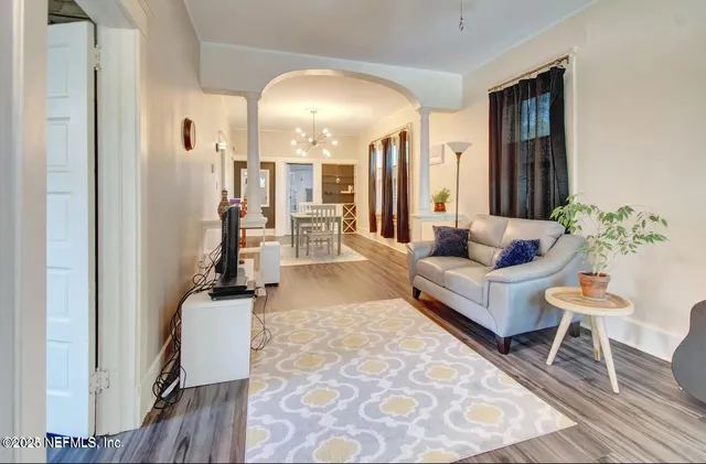 a living room with furniture and wooden floor