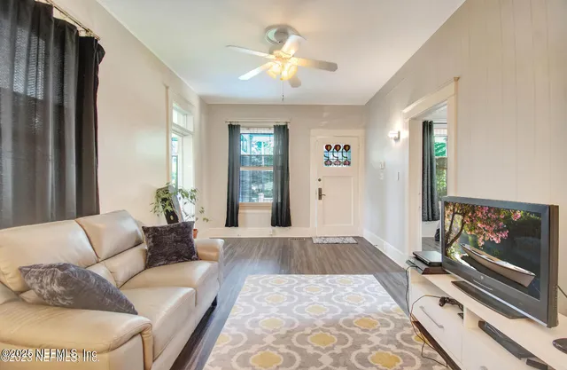 a living room with furniture and a chandelier