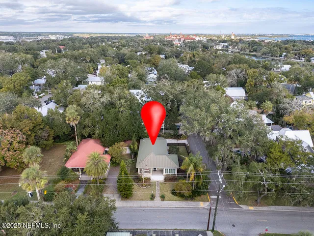 an aerial view of a house with a swimming pool outdoor seating and yard